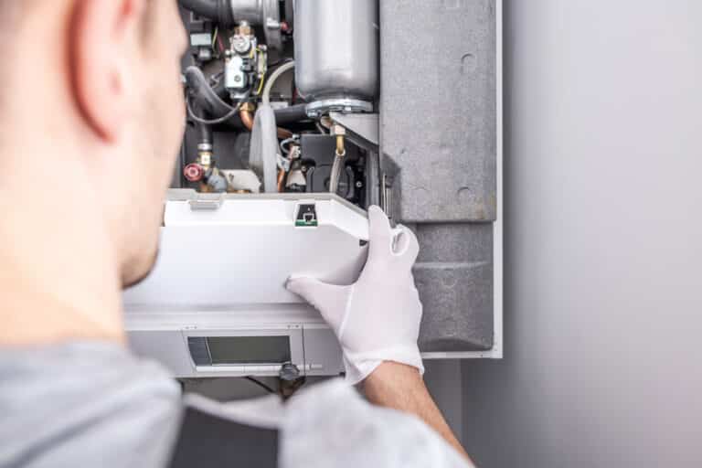 Technician fixing a furnace