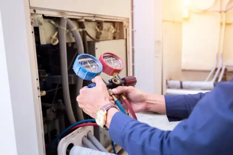  HVAC technician performing a maintenance check on an HVAC unit 