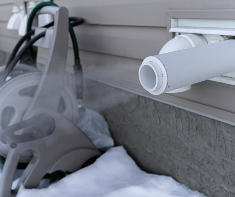 A furnace pipe releasing steam in the winter