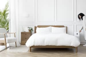  A woman turns on an air scrubber which is next to her bed 