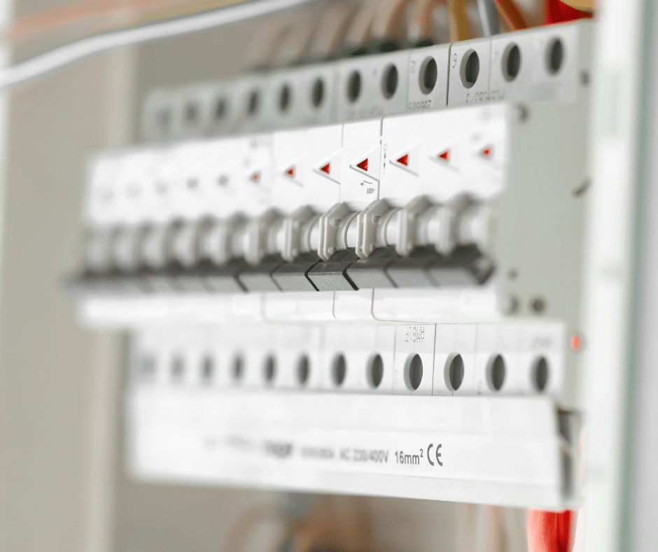 An electrical panel with many breaker switches