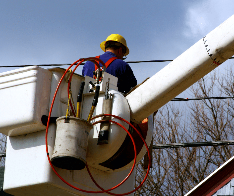 A technician in a bucket truck