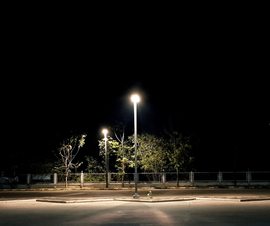 A light at the end of an empty parking lot 