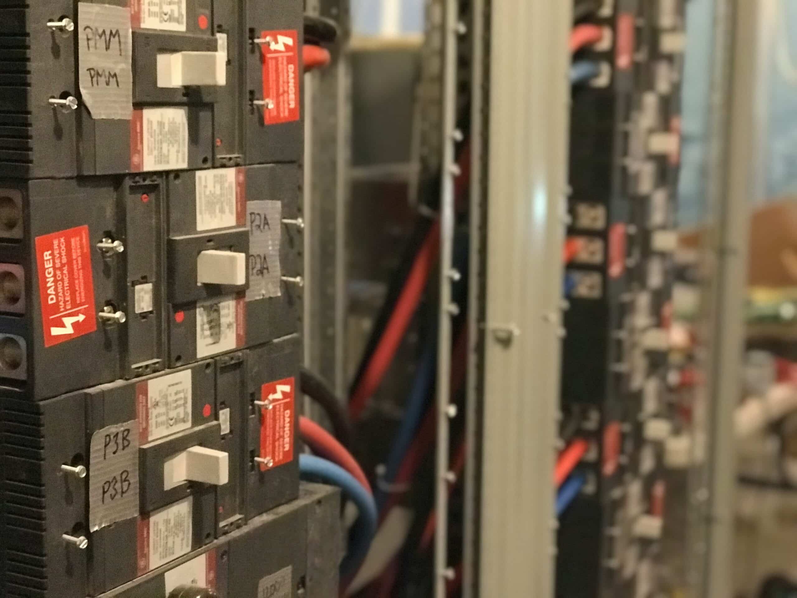 An electrical panel with an open front door