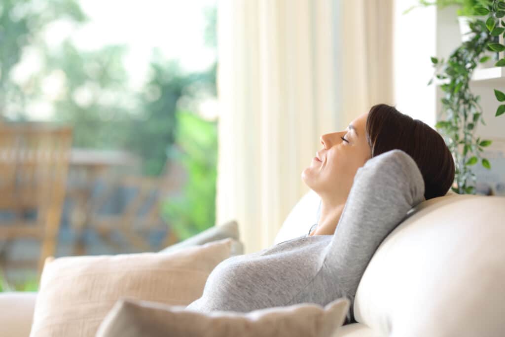 Woman enjoying clean indoor air in living room