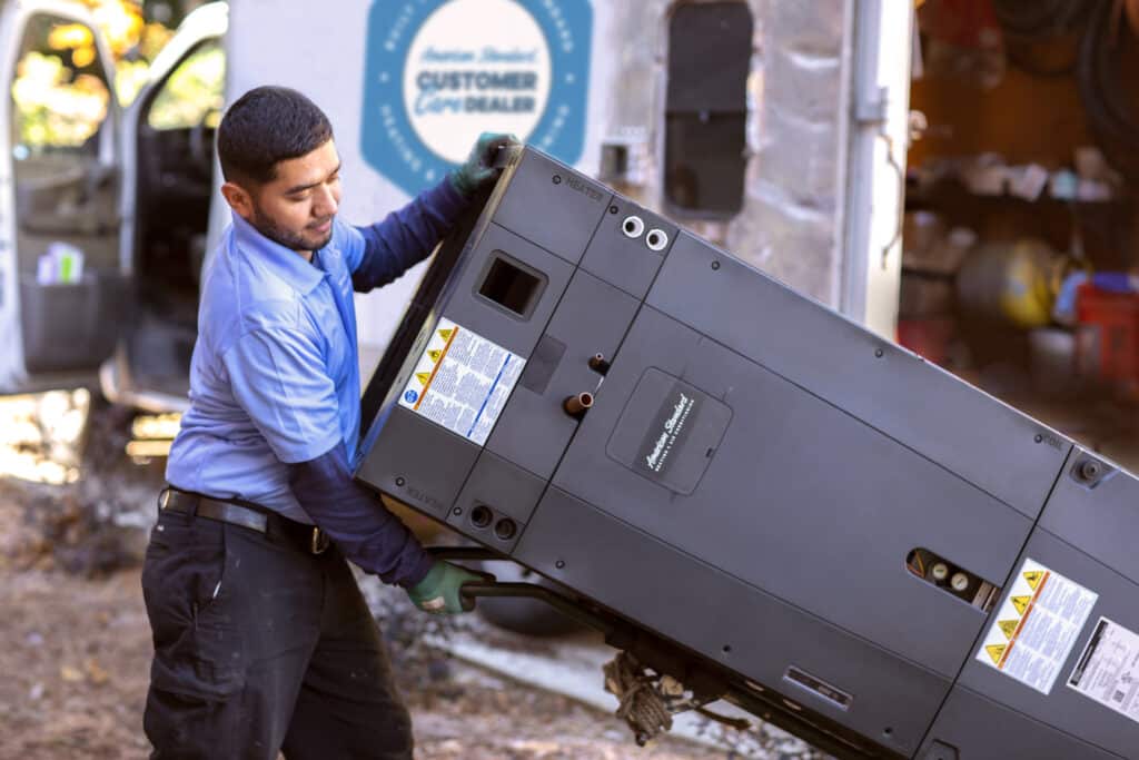 HVAC tech installing heat pump